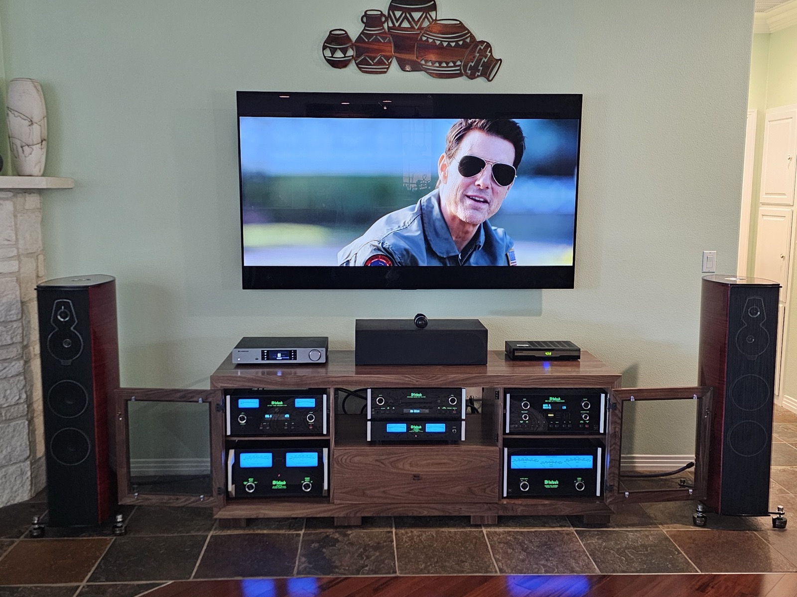 A B&A solid walnut media console housing a McIntosh component system, flanked by floor-standing speakers in a customer's home